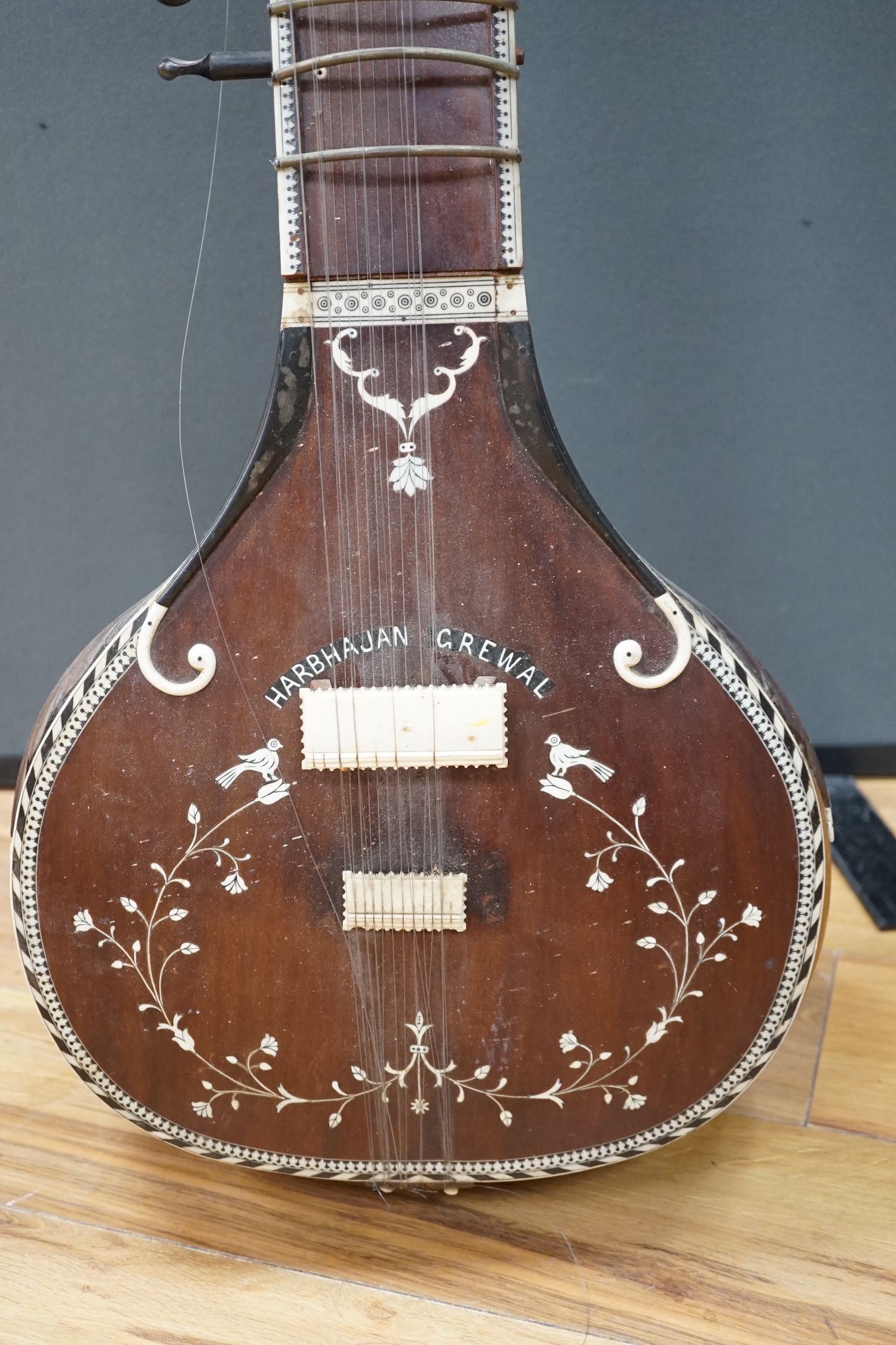 An Indian sitar, with ivory bridge and decoration, inlaid with ‘Harbhajan Grewal’ overall length 129cm CITES Submission reference LA16A6BD